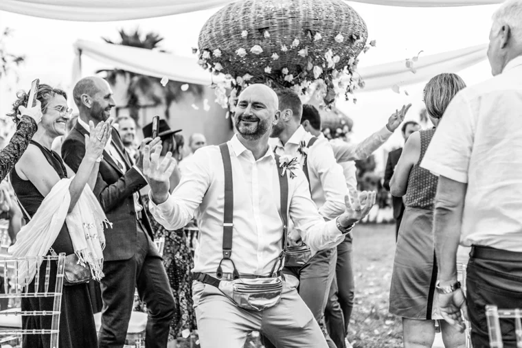 Groom dancing among wedding guests