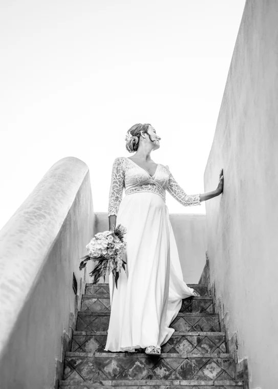 Bride on pink architectural stairs