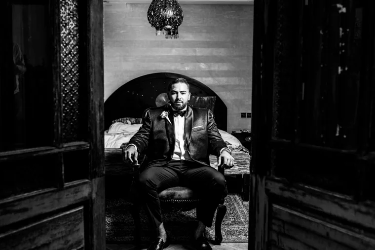Groom seated in an ornate room