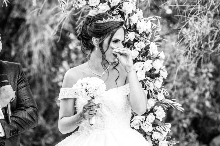 Bride holding a bouquet of white roses