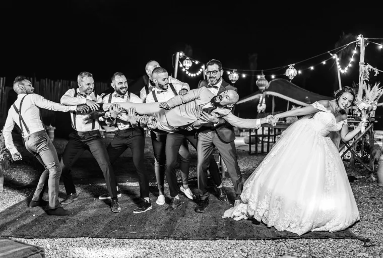 Friends celebrating around the newlyweds at night