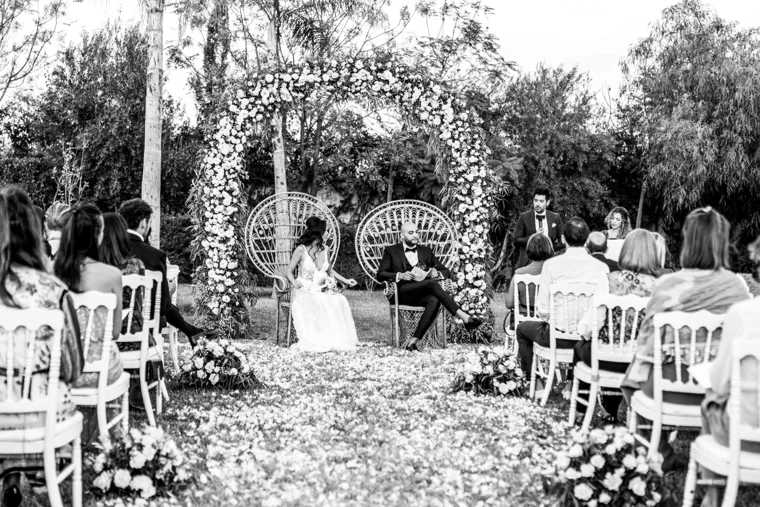 Outdoor wedding ceremony surrounded by greenery