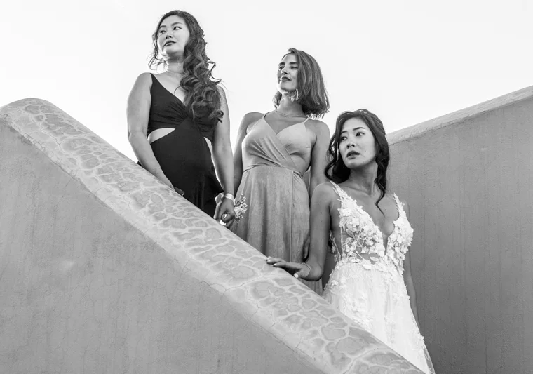 Bride and bridesmaids on architectural stairs