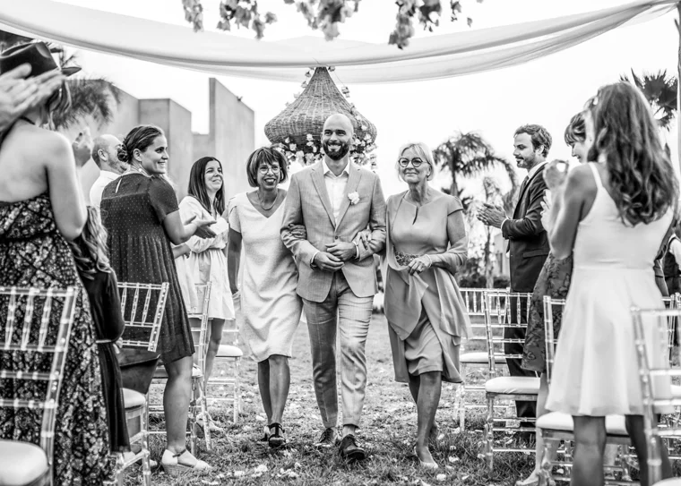 Wedding guests applauding newlyweds