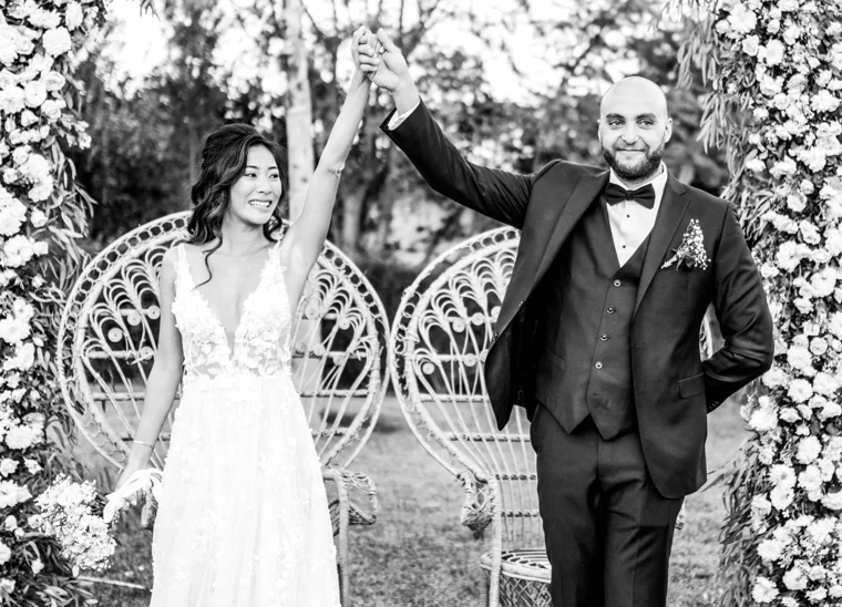 Newlyweds raising their joined hands