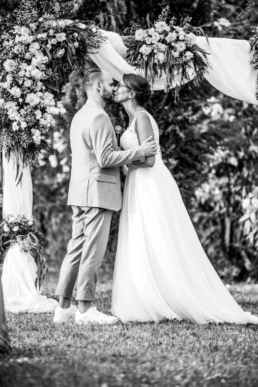 Wedding couple embracing among trees