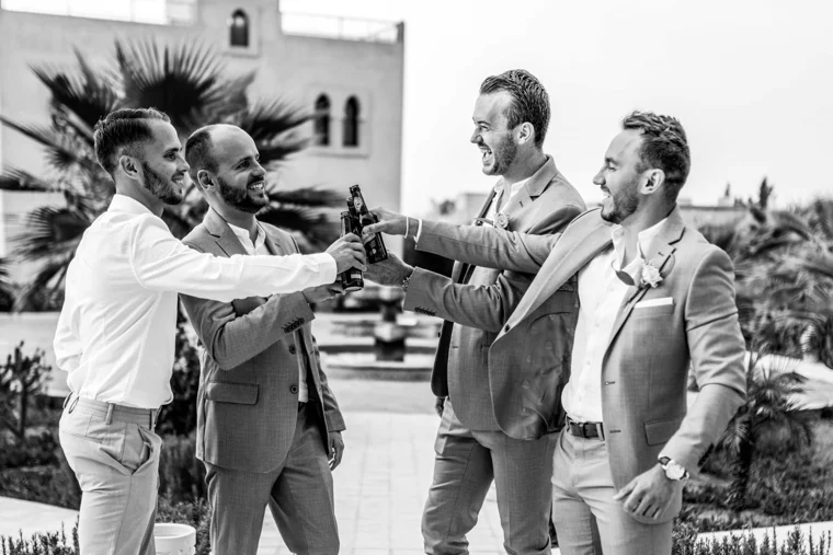 Groom and friends raising a toast