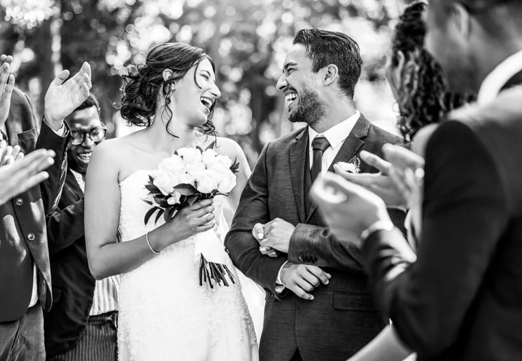Newlyweds walking beneath confetti