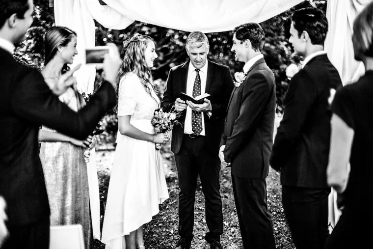 Outdoor wedding ceremony with an officiant