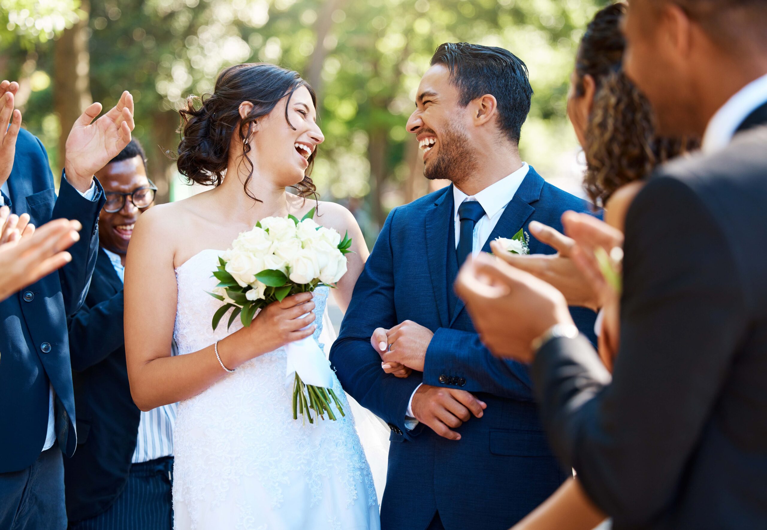 Happy bride and groom laughing and looking joyful after wedding ceremony and ready to celebrate wit.
